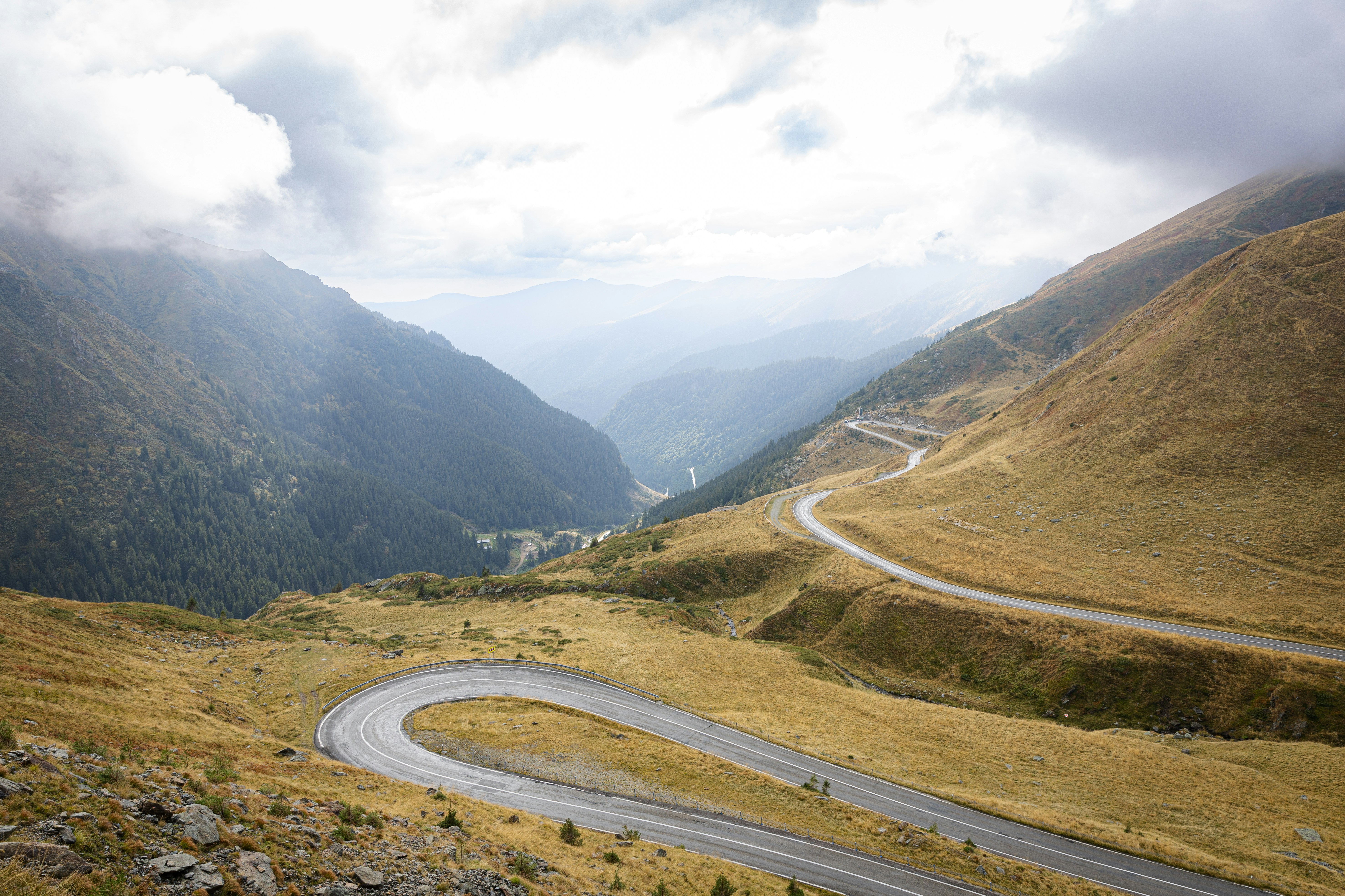 A winding road in the middle of a mountain range