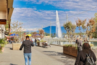 A man walking down a street with a yellow umbrella