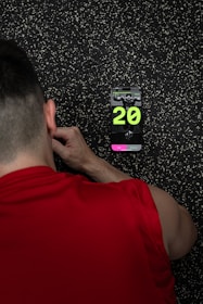 A man standing in front of a wall with a clock on it