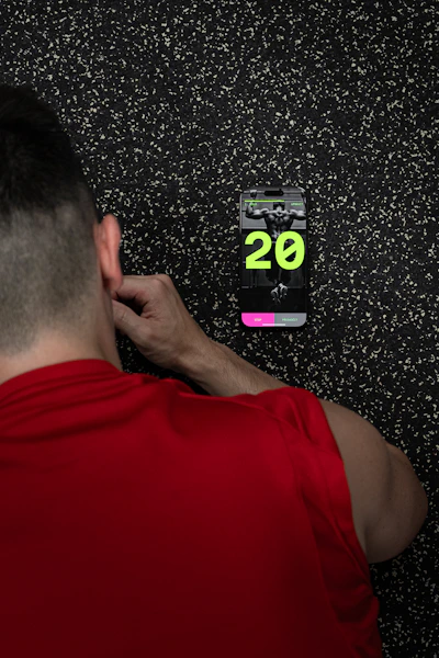 A man standing in front of a wall with a clock on it