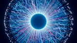 A close up of a blue eyeball in the dark