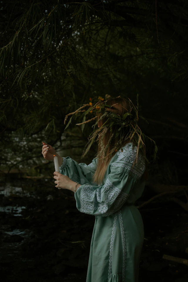 A woman with long hair standing in a forest