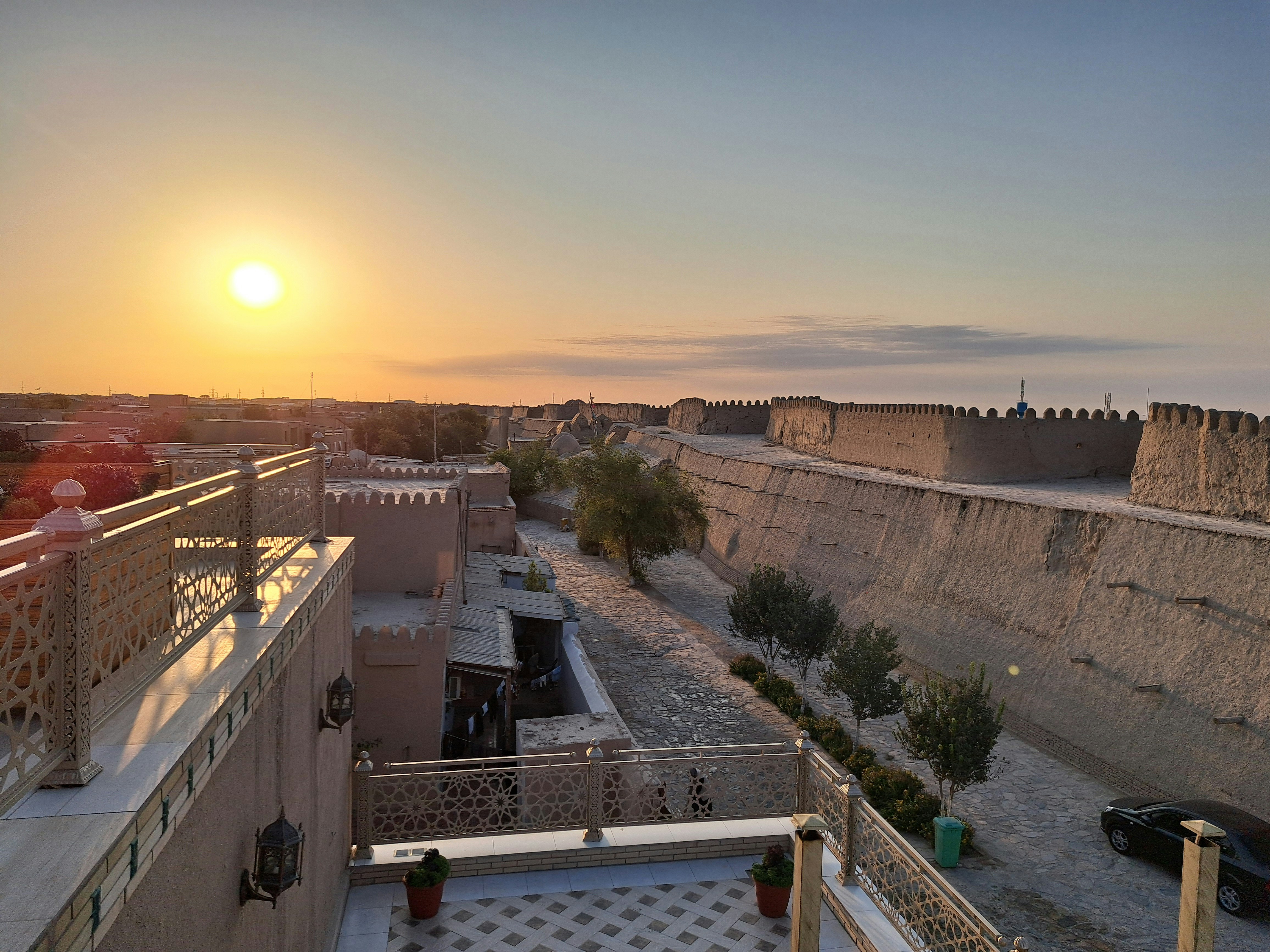 Ancient Mesopotamian ruins at sunset, crumbling mud brick walls, arid desert landscape, warm golden light