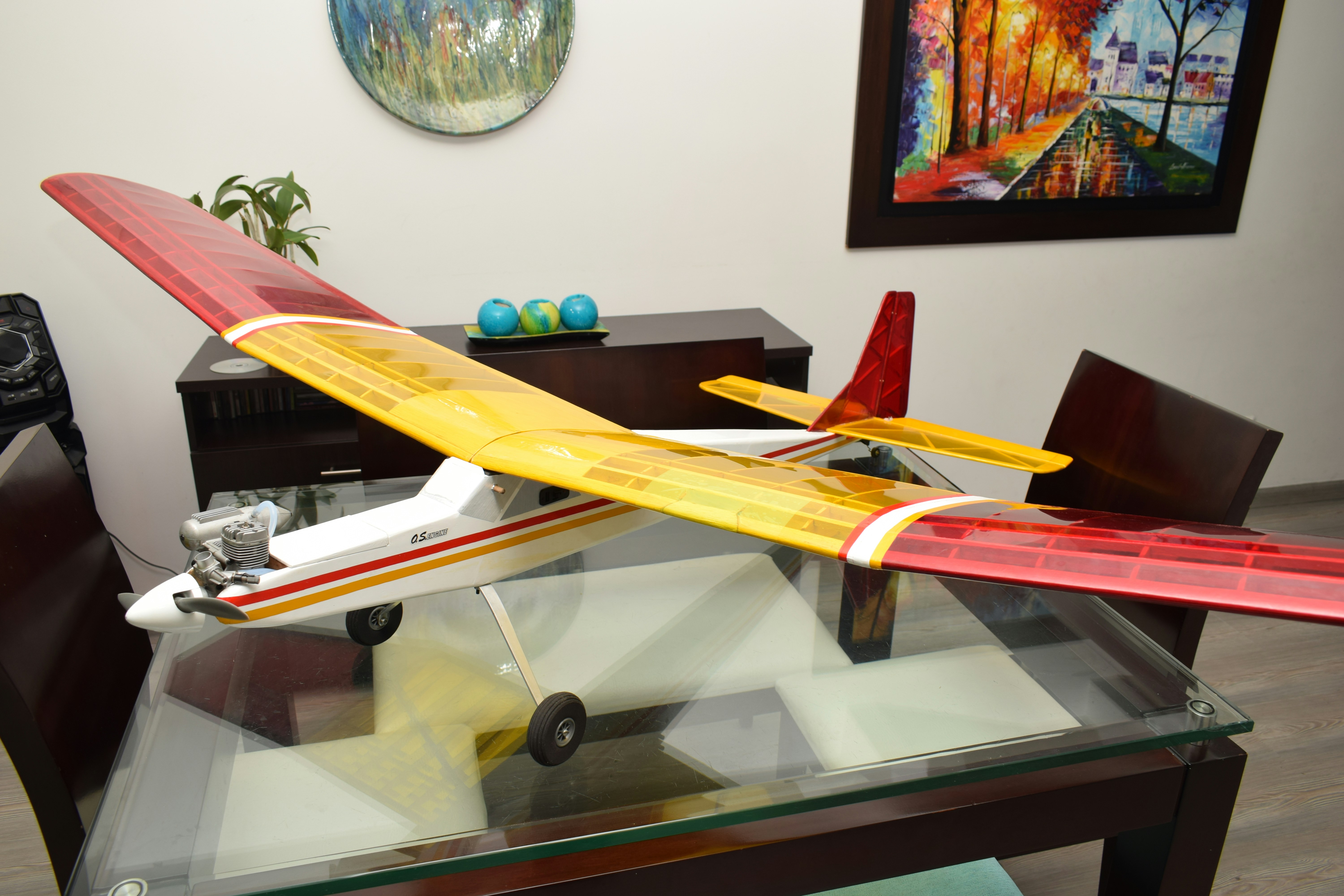 A model airplane sitting on top of a glass table