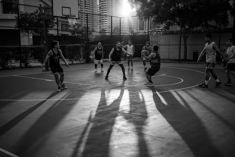 A group of young men playing a game of basketball