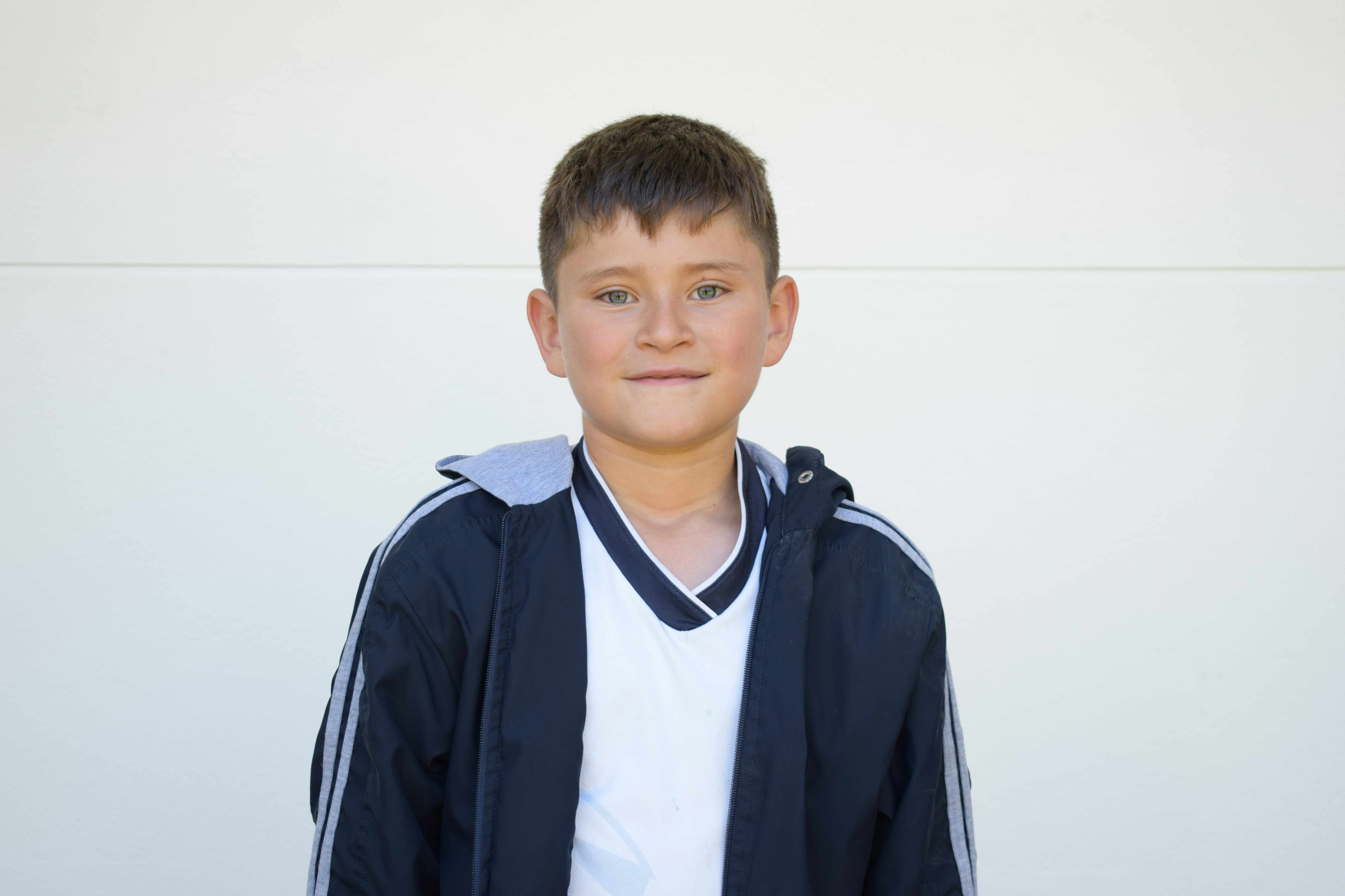 A young boy is posing for a picture
