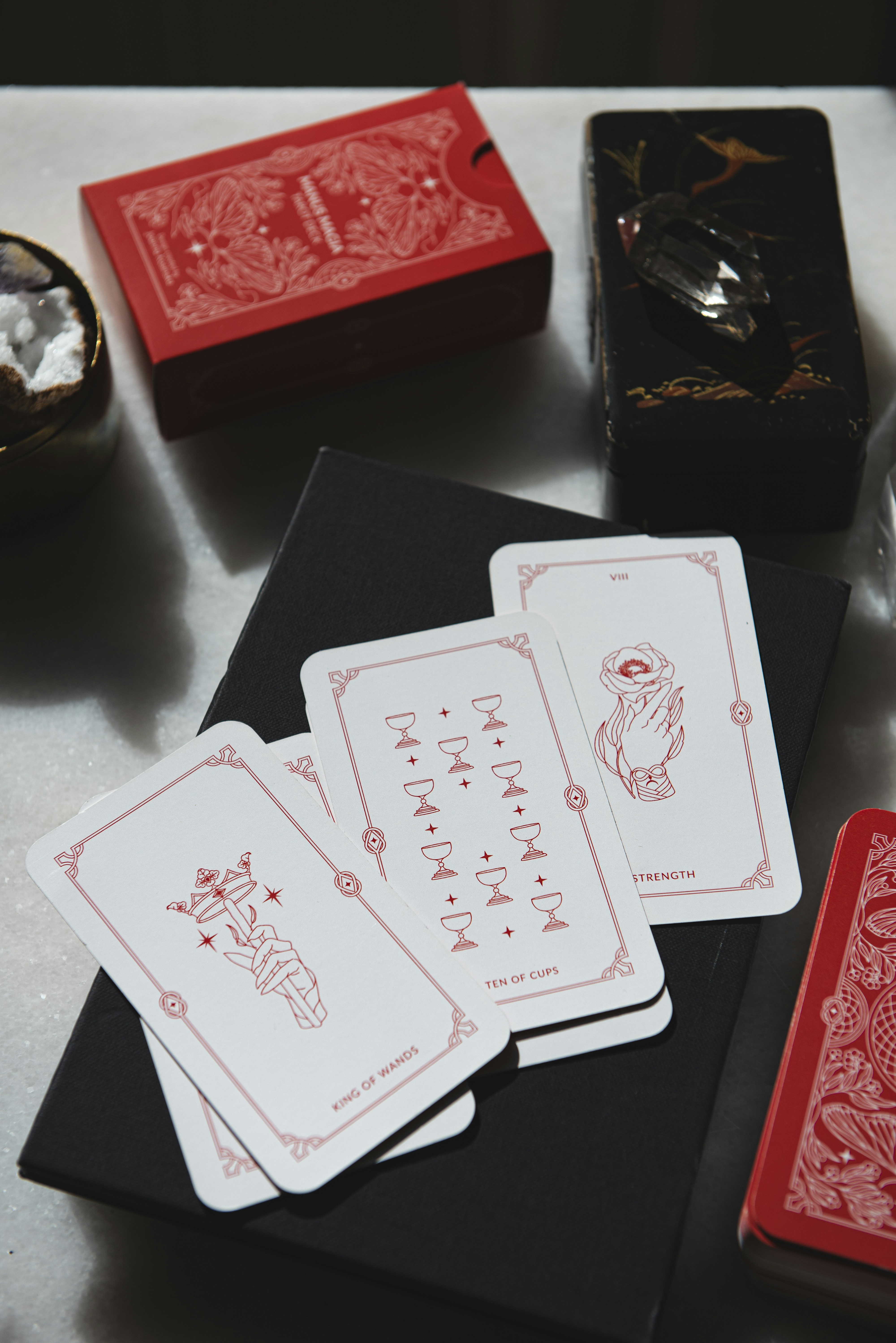 A table topped with cards and a glass of wine
