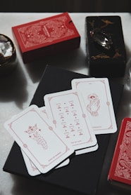 A table topped with cards and a glass of wine