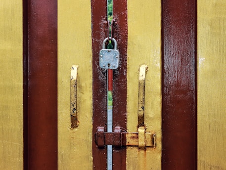 A close up of a door handle on a wooden door