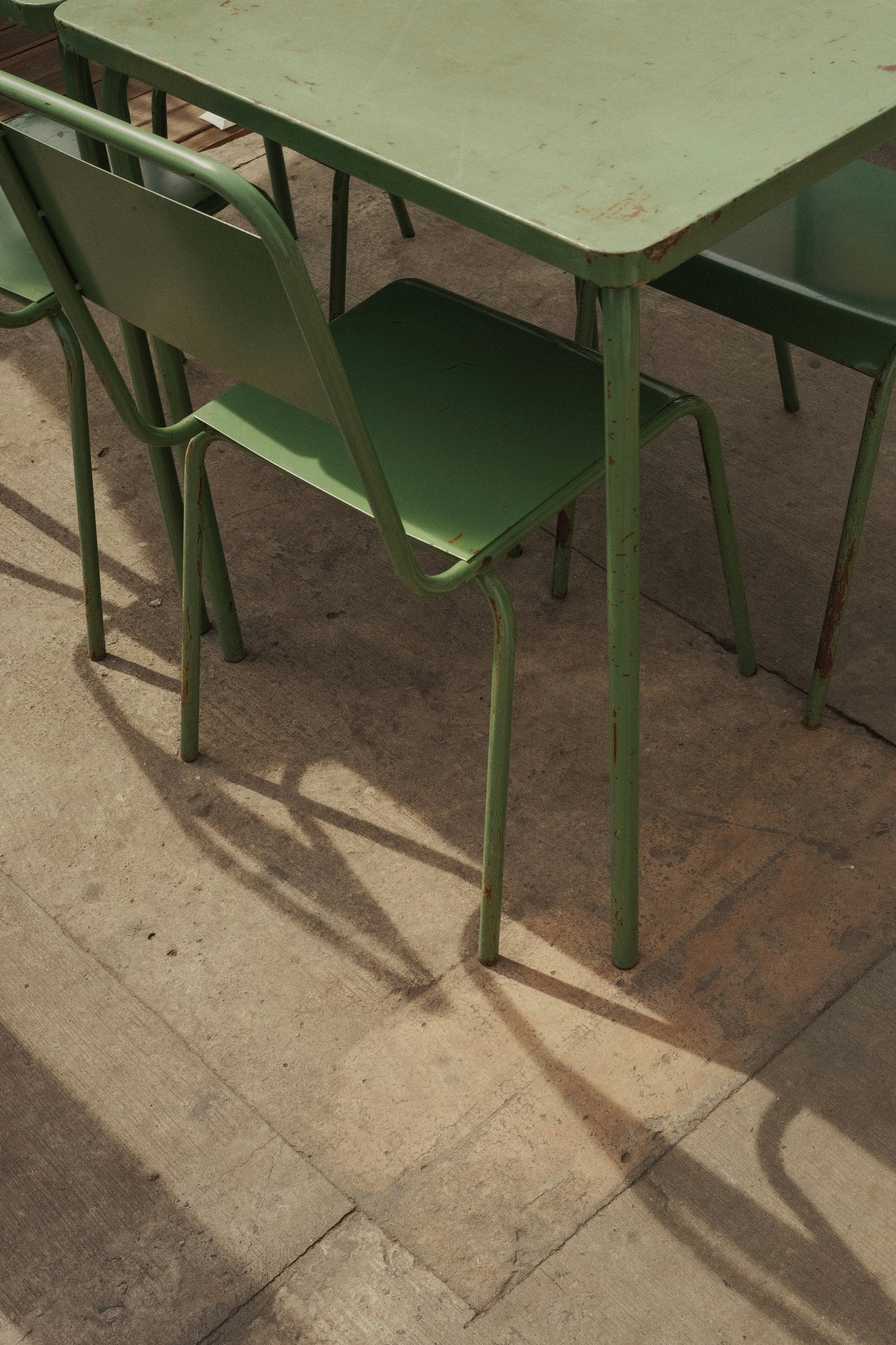 Clean patio area with outdoor furniture, bright daylight, freshly cleaned concrete
