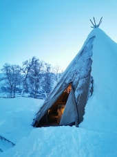 A snow covered building with a sky background