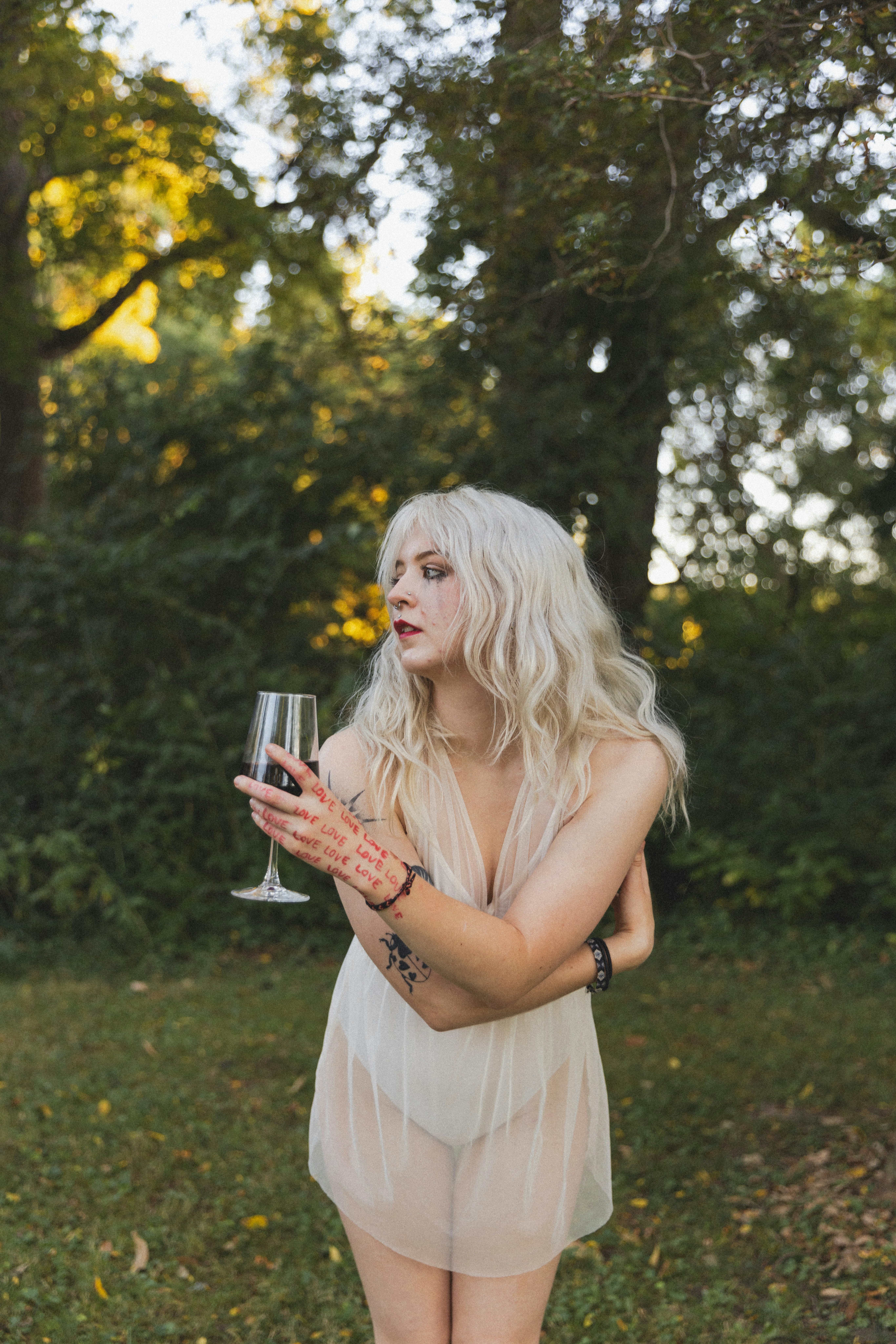 A woman in a short dress holding a wine glass
