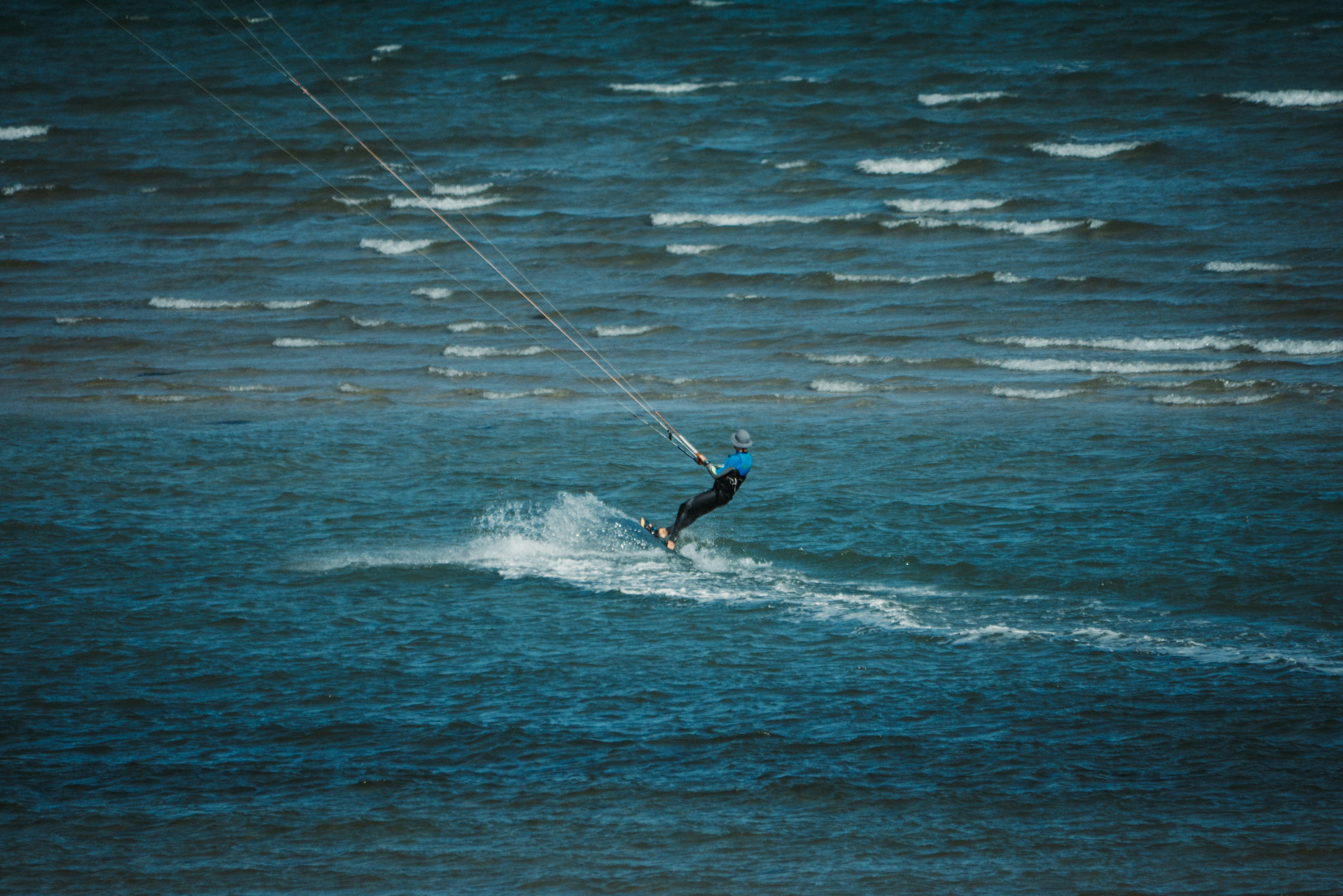 A man riding a kiteboard on top of a body of water