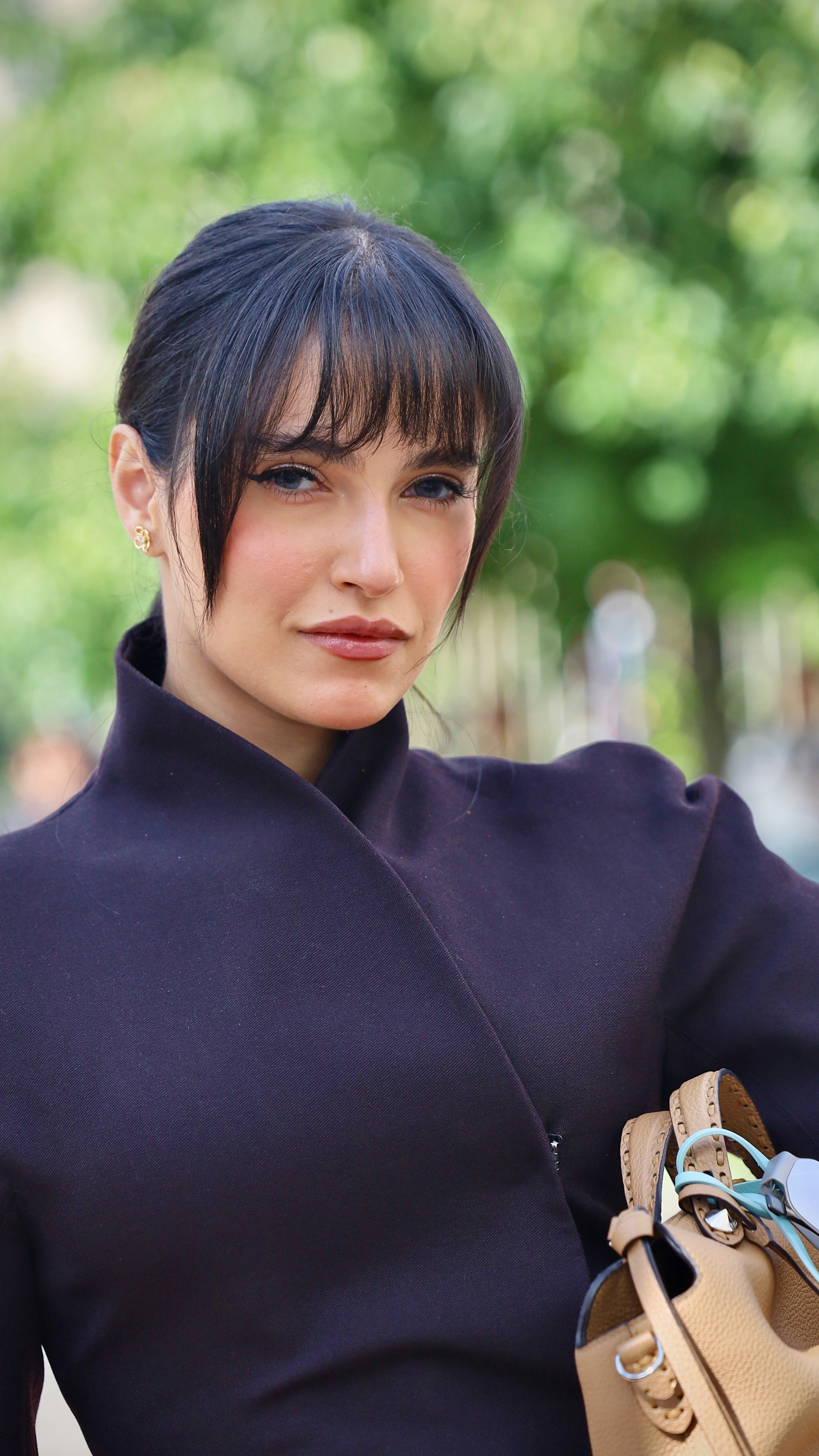 Woman with dark hair outdoors