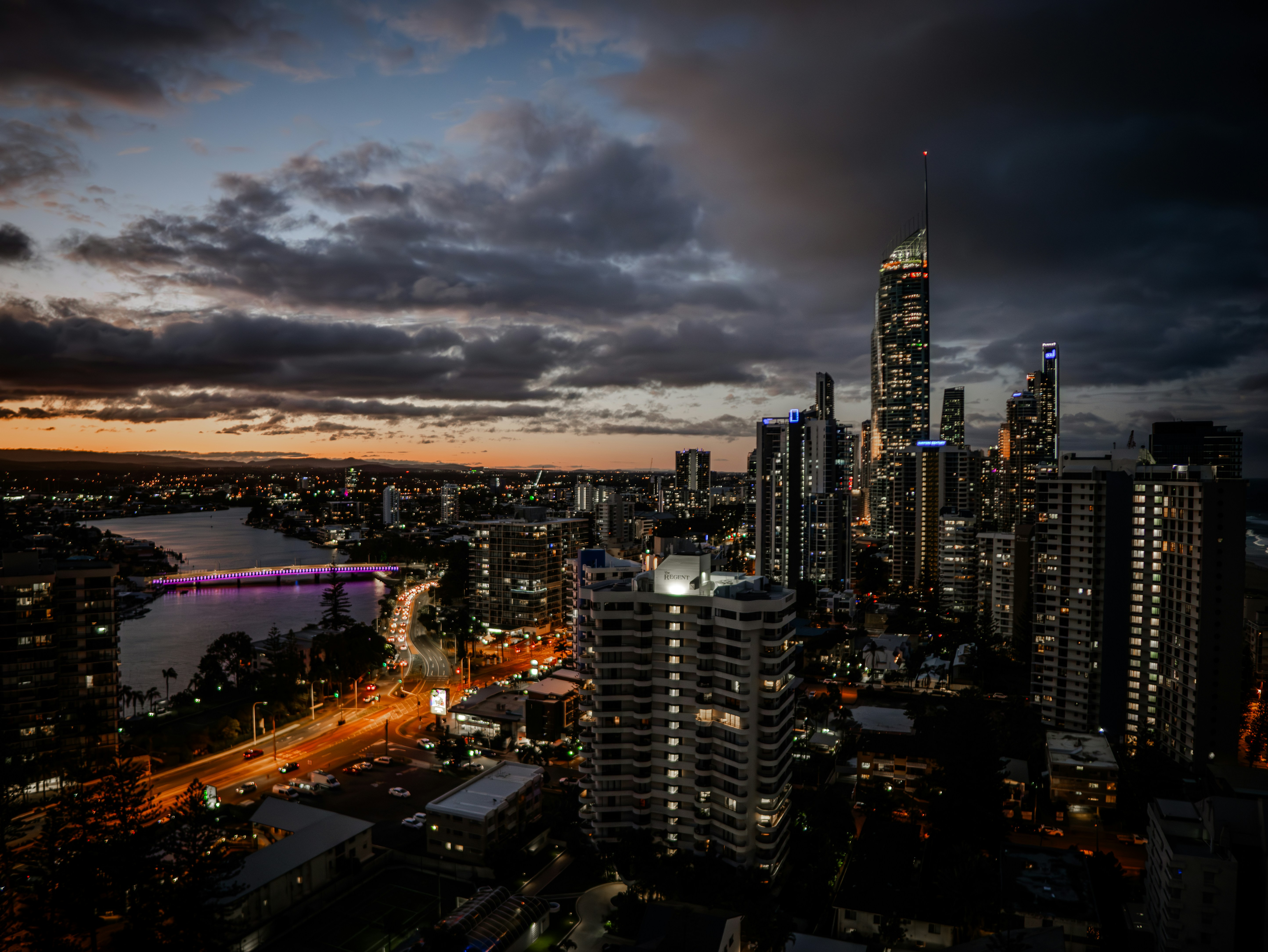A view of a city at night from the top of a building