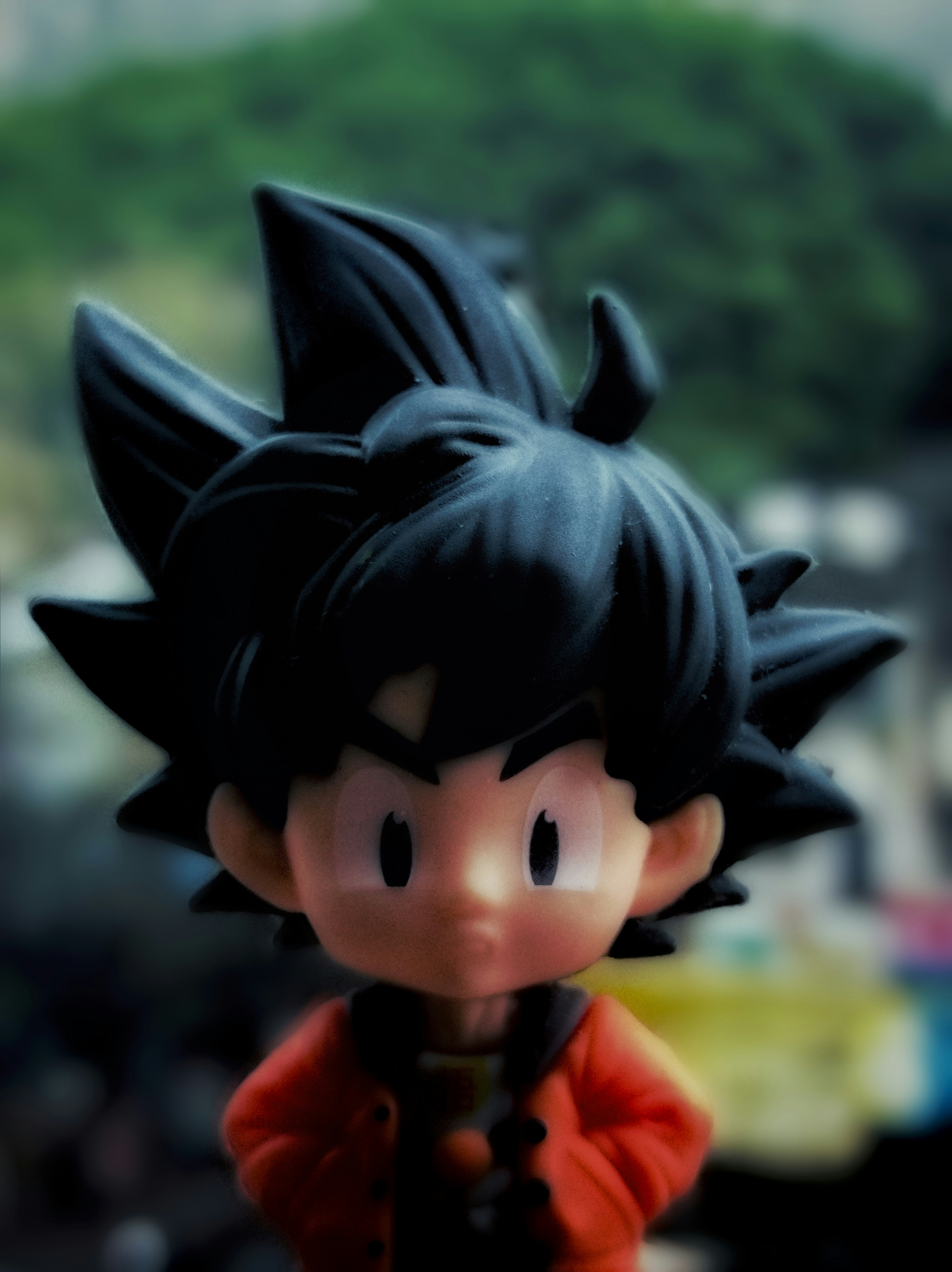 A close up of a toy of a boy with black hair