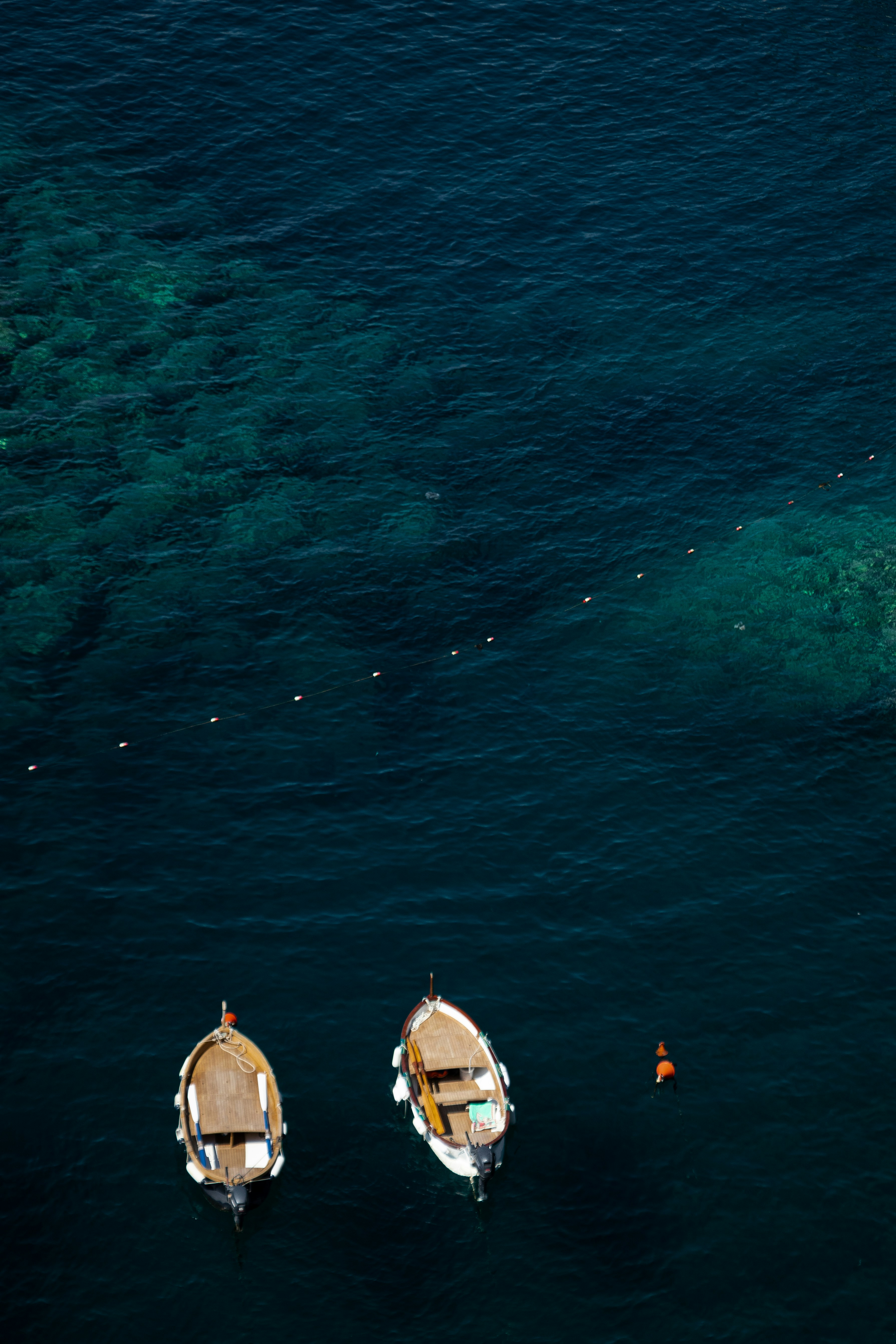 A group of boats floating on top of a body of water