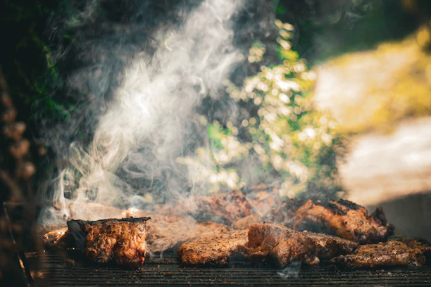 A close up of a grill with food cooking on it