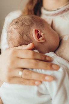 A woman holding a baby in her arms
