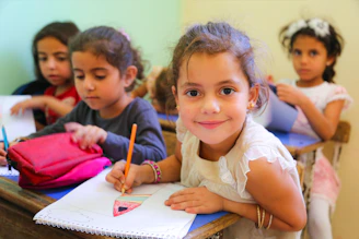 A group of young children sitting at a desk