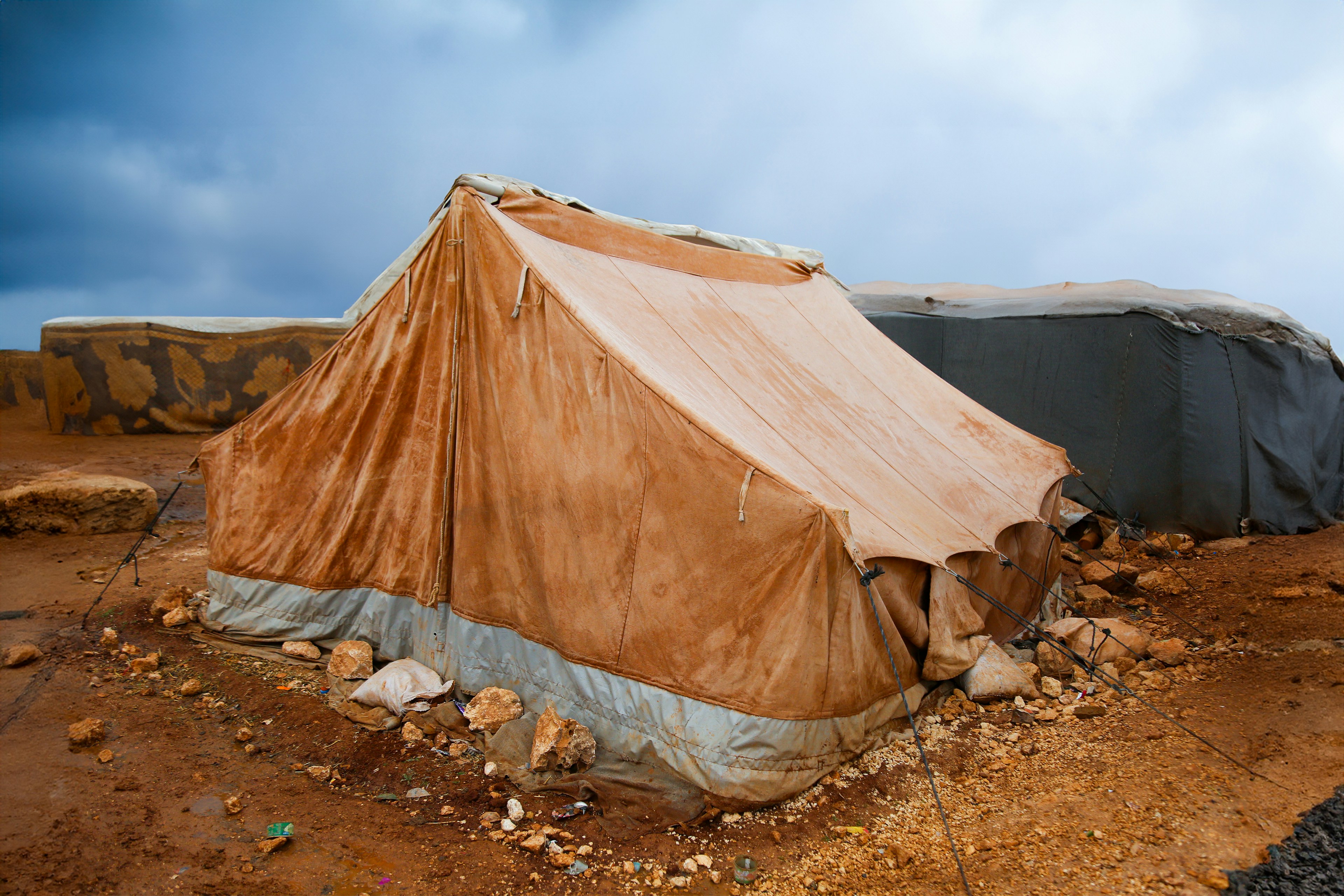 A tent sitting on top of a dirt field