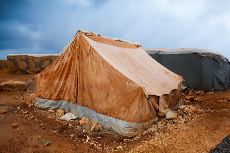 Displacement camp tent on arid ground