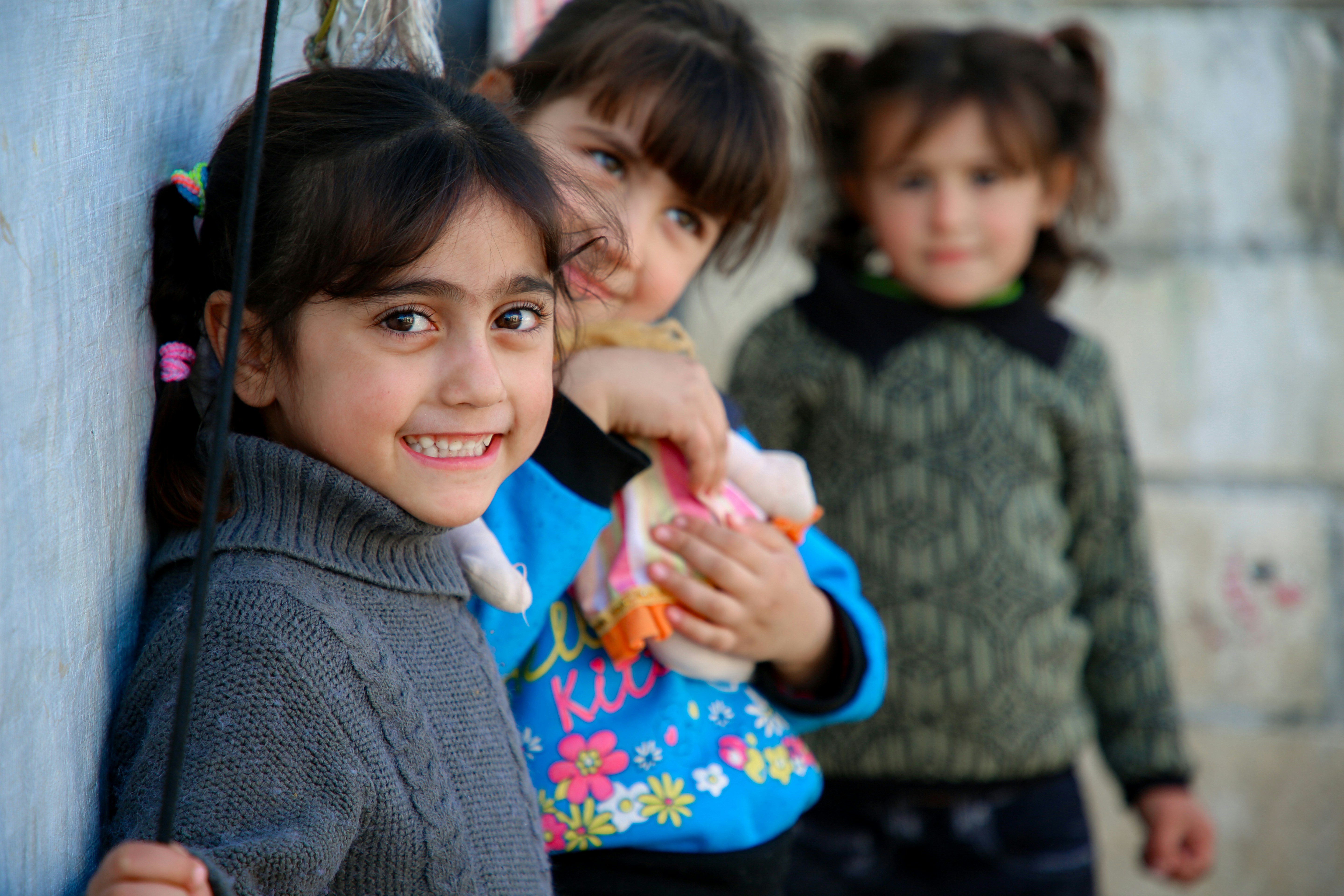 A group of young children standing next to each other
