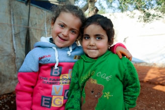 Two little girls standing next to each other