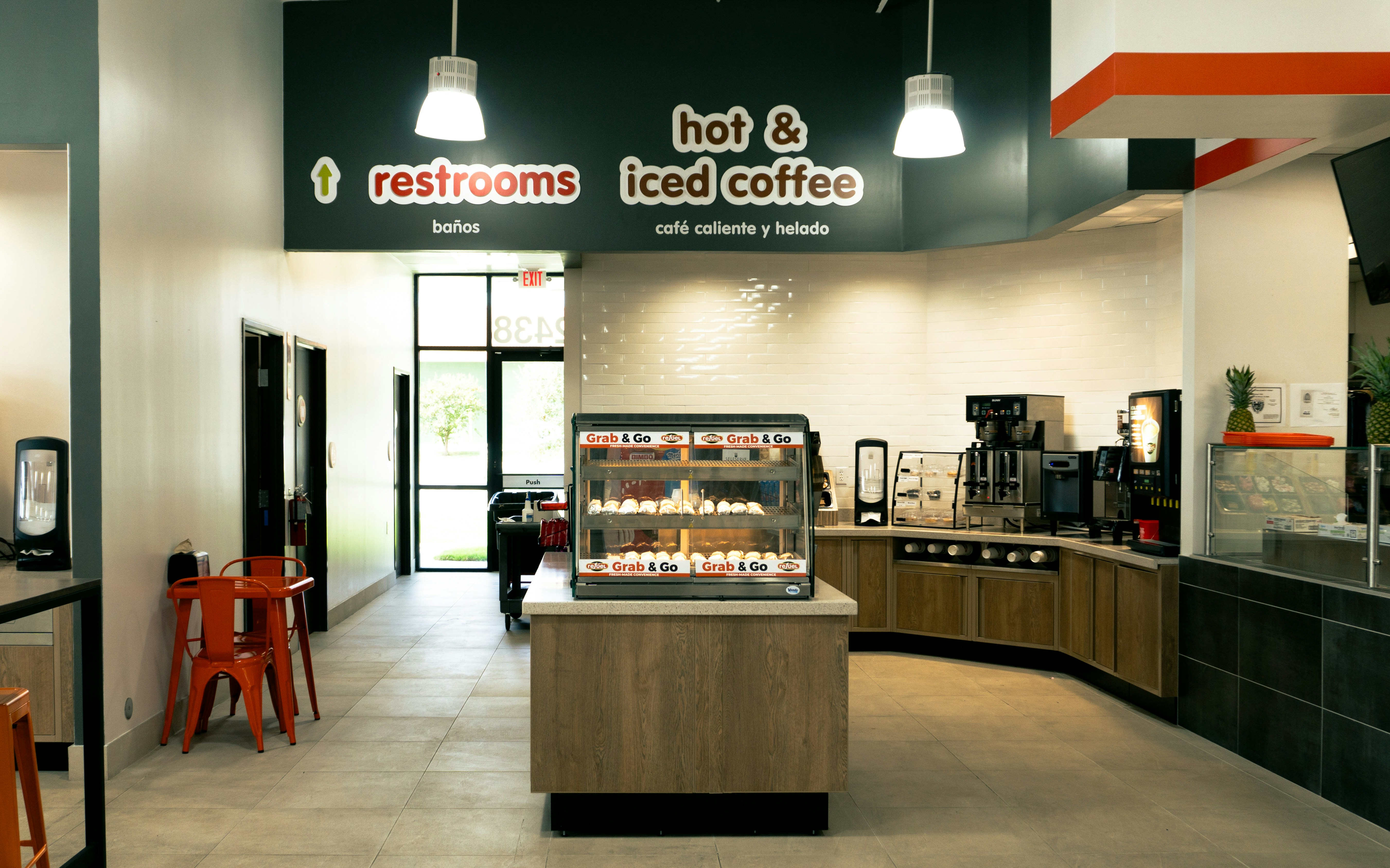 The inside of a coffee shop with tables and chairs