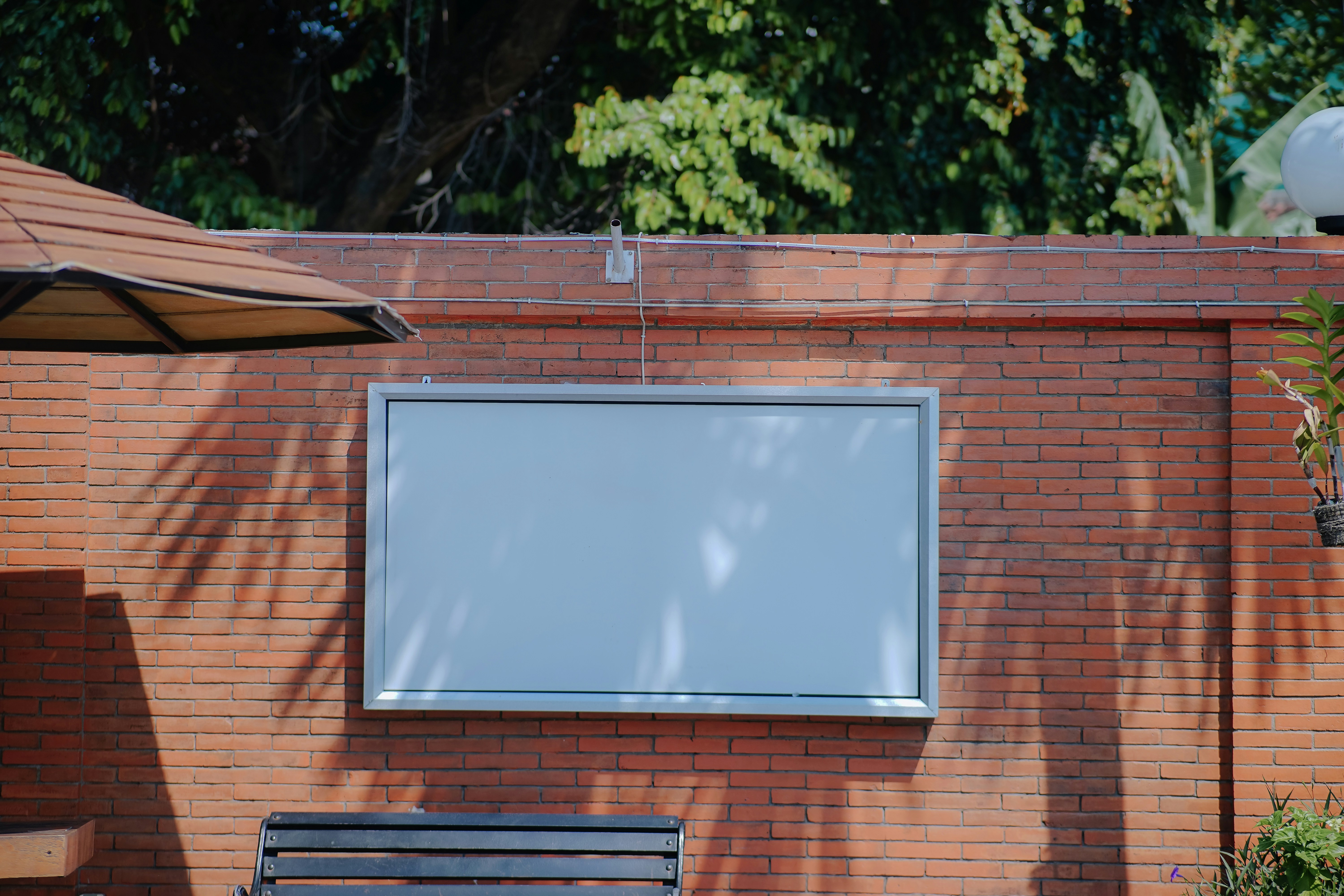 A wooden bench sitting in front of a brick building