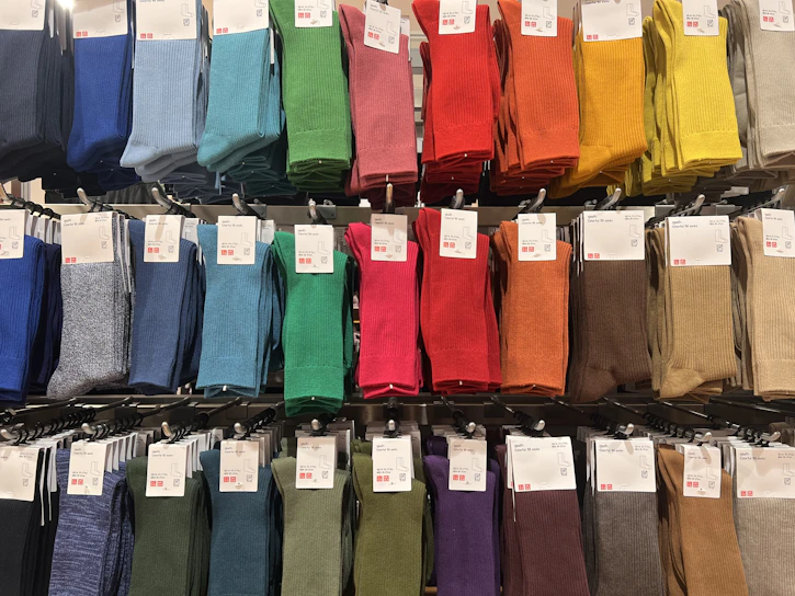 A display case filled with lots of different colored socks