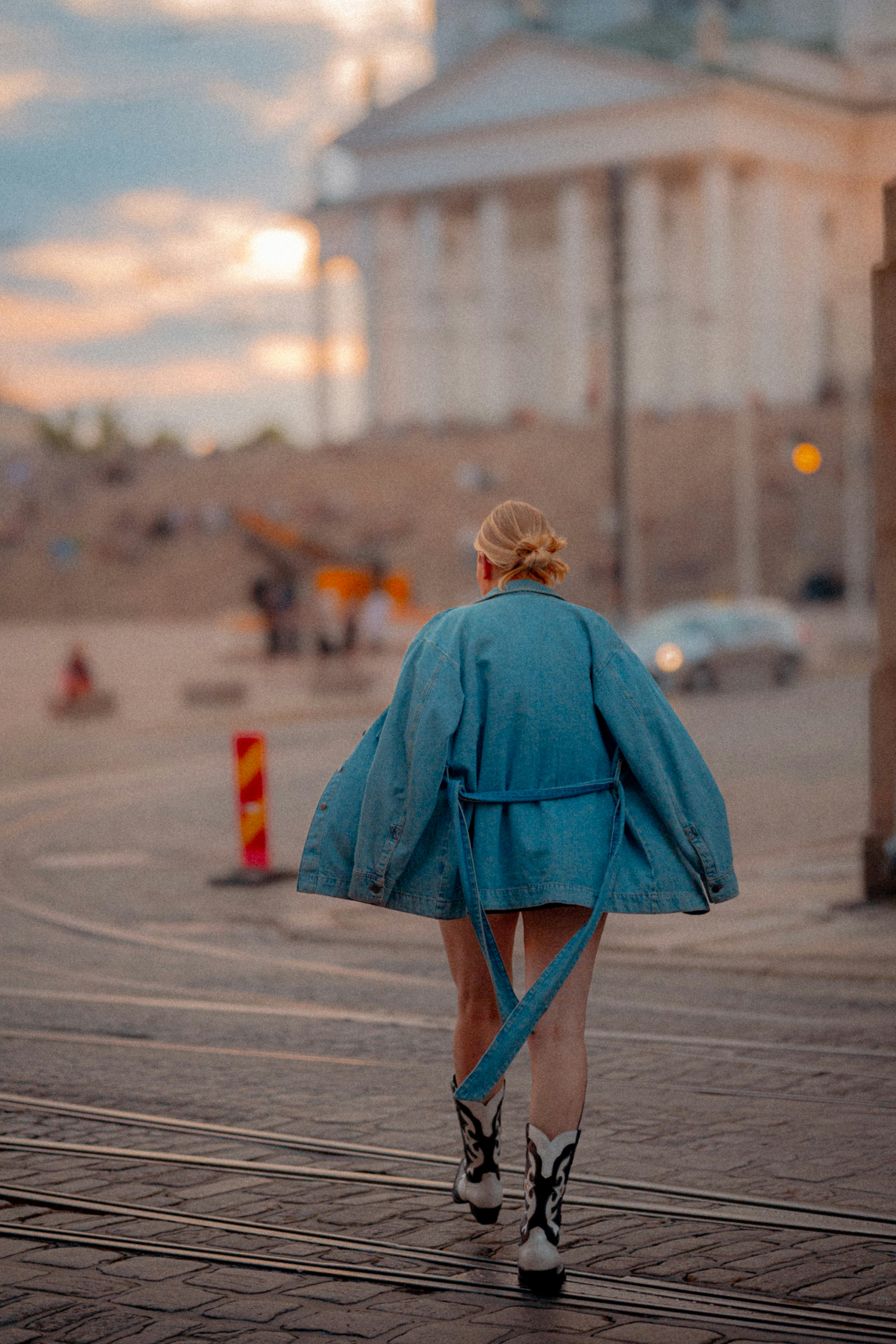 A woman in a blue coat walking down a street photo – Free Helsinki ...