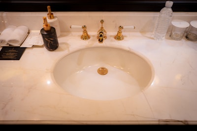 A bathroom sink with a marble counter top