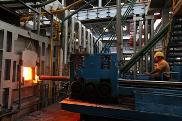 A man in a factory working on a piece of machinery