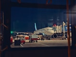 An airplane is parked at an airport at night