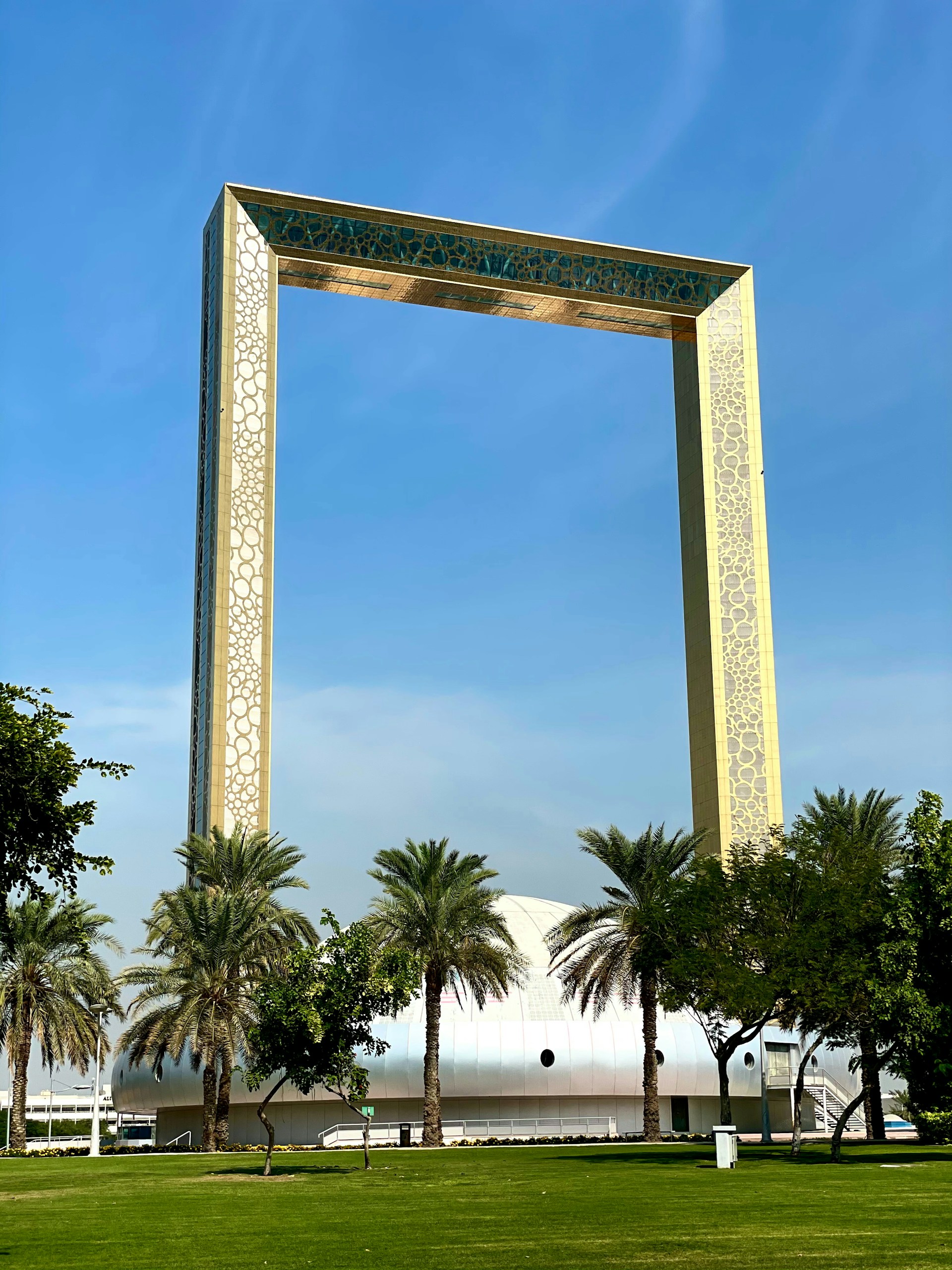 A large arch in the middle of a park