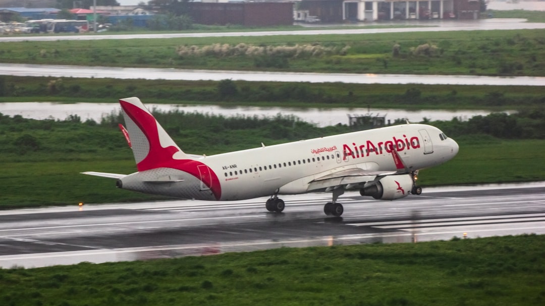 A large passenger jet taking off from an airport runway, AirArabia A320