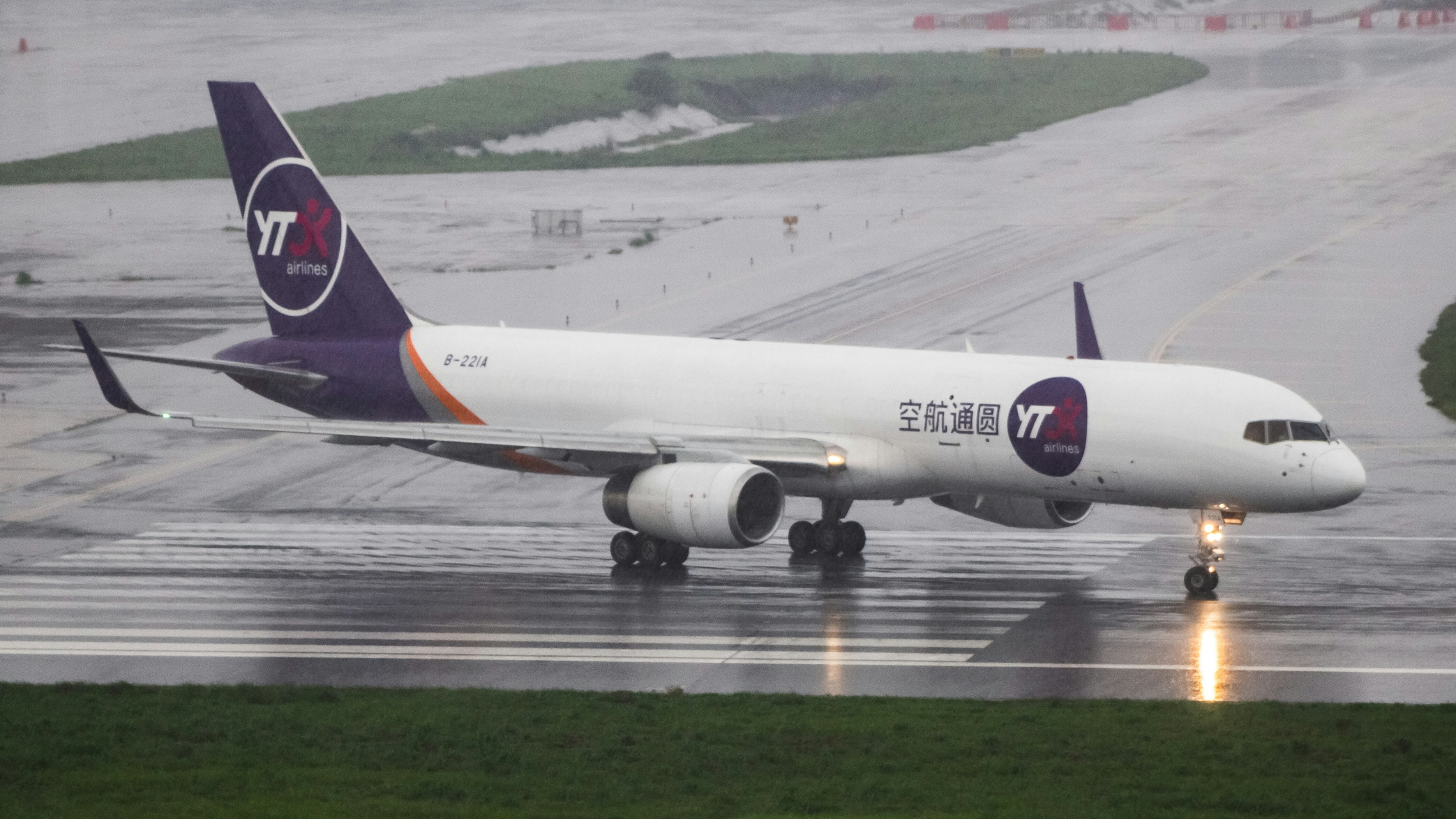A large jetliner sitting on top of an airport runway, 