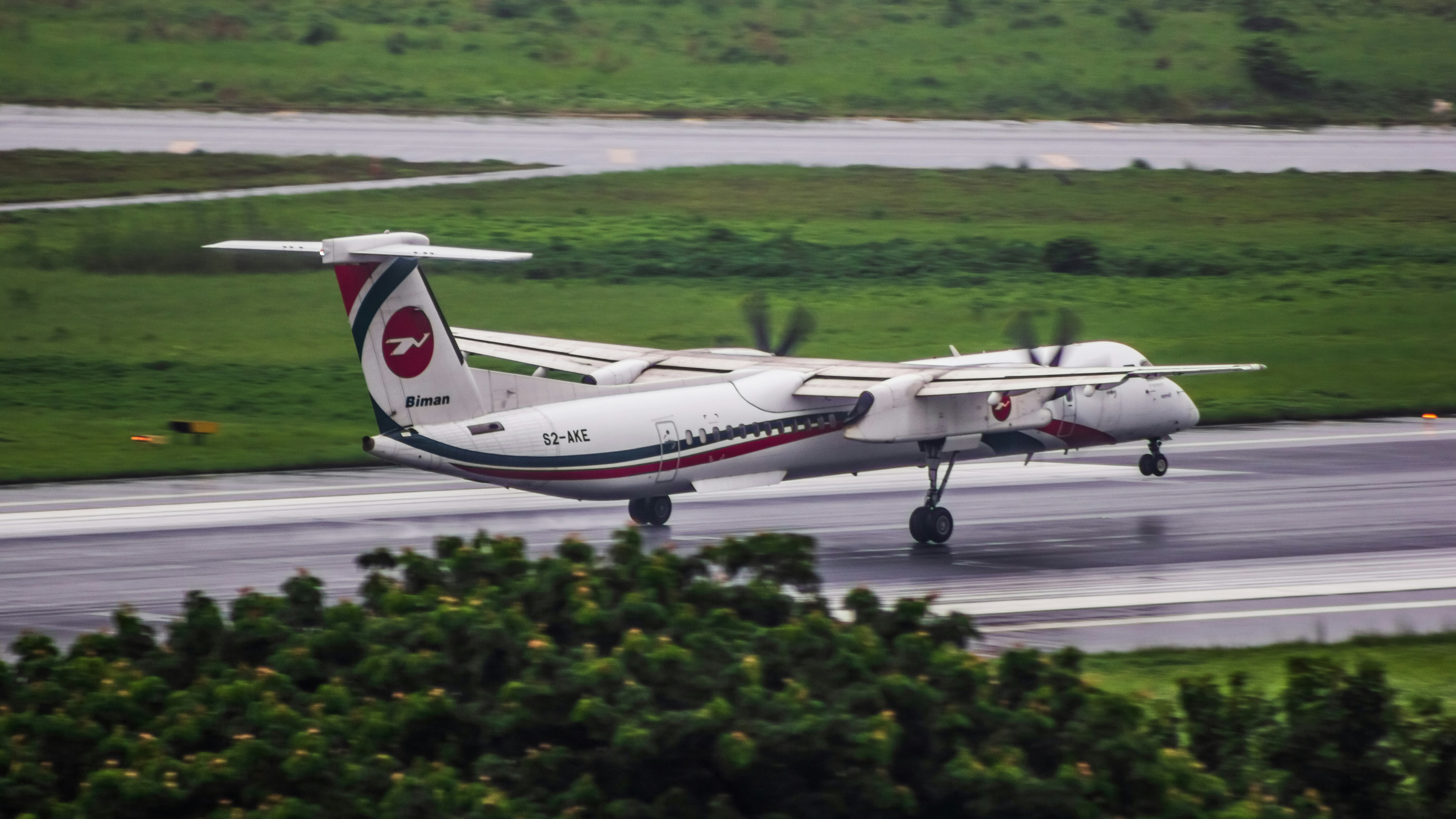A small plane is on the runway of an airport