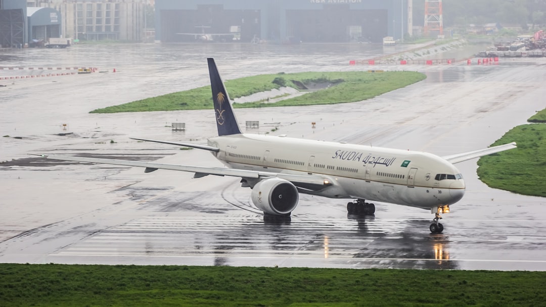 A large jetliner sitting on top of an airport runway, 
