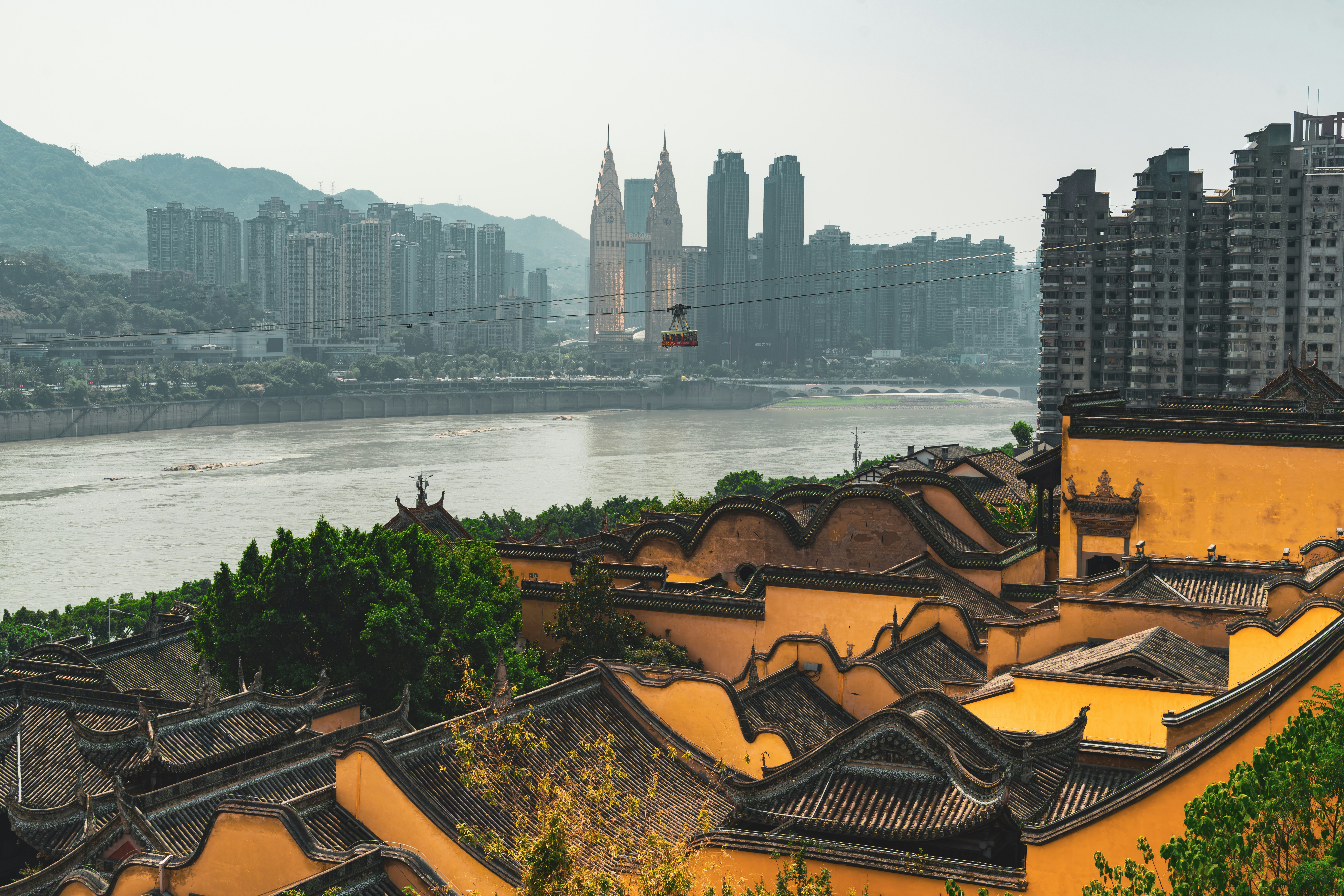 A view of a city with a river in the background