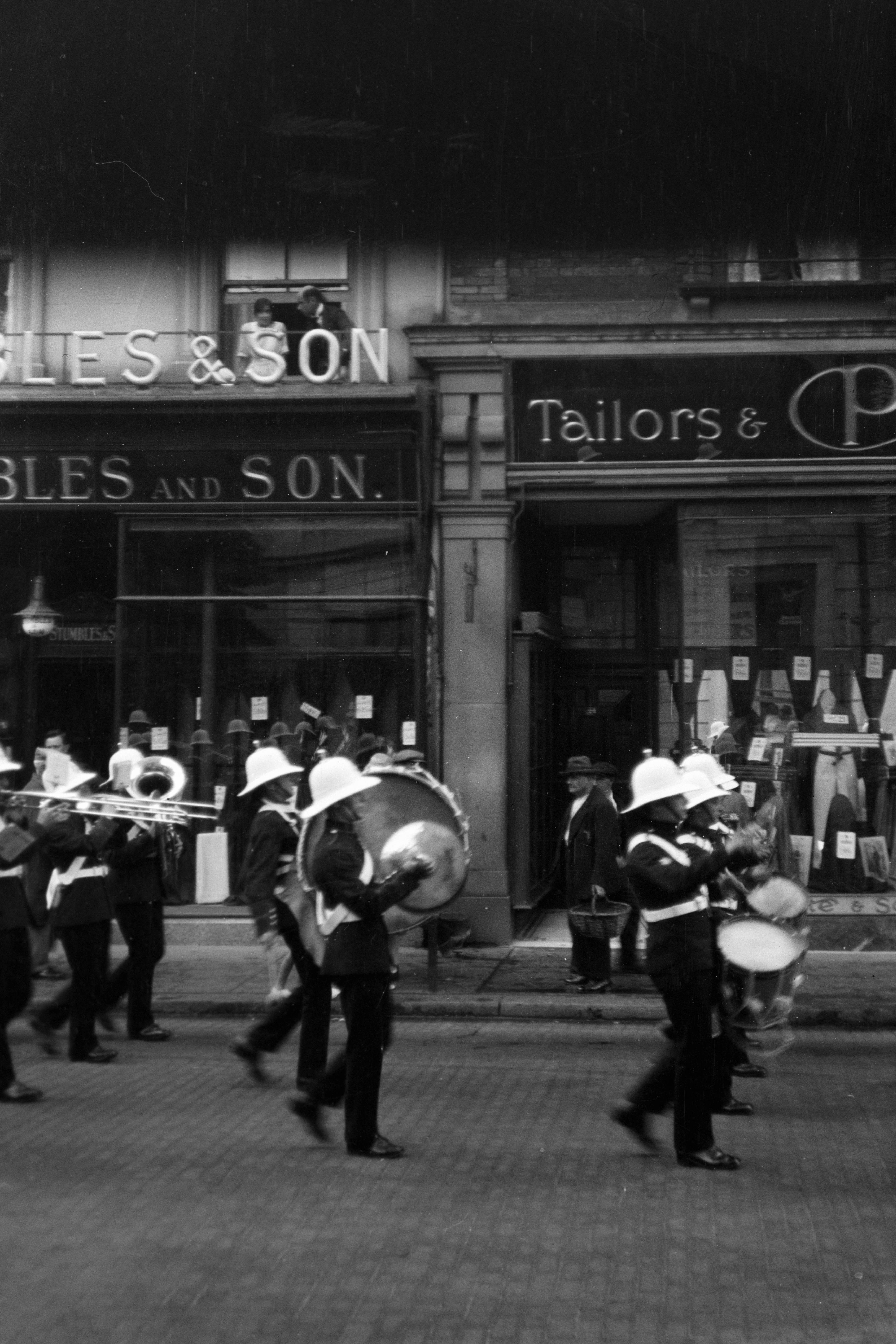 A group of people that are standing in front of a building
