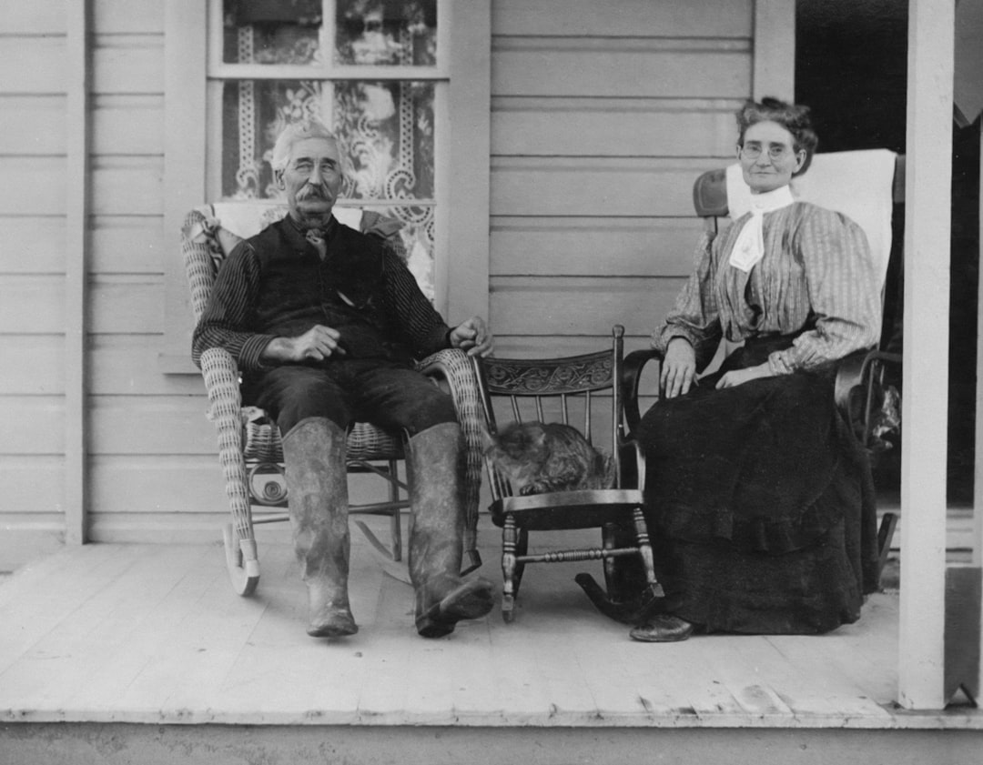older couple holding hands sitting on porch reconciling