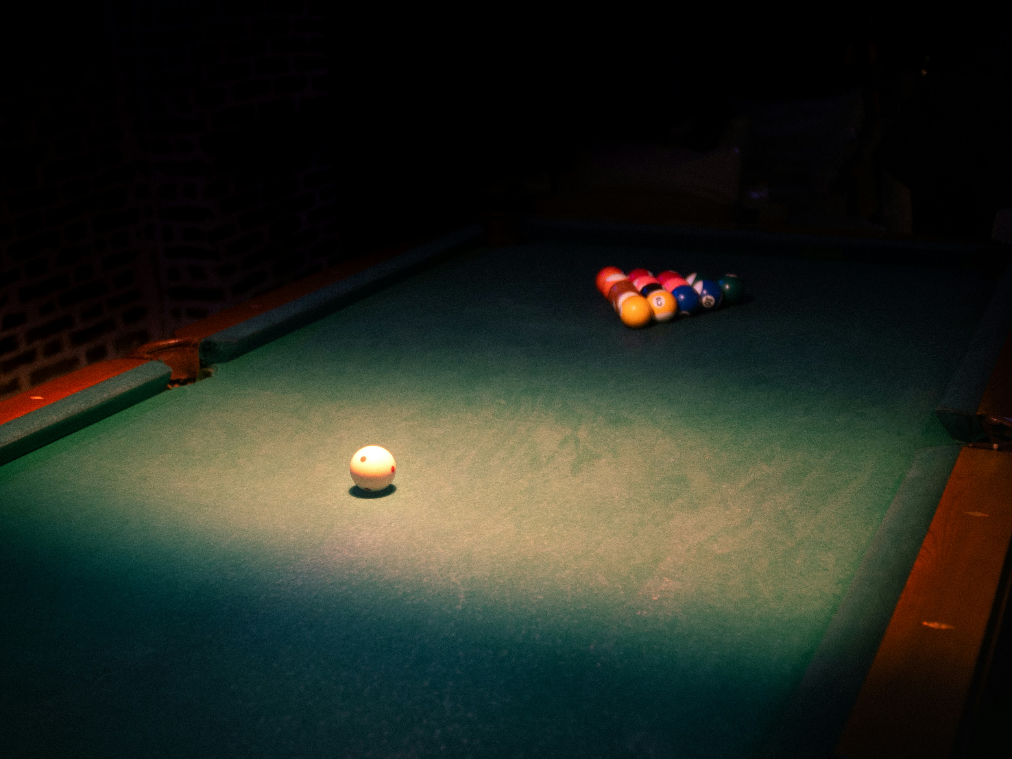 A pool table with a pool ball on it