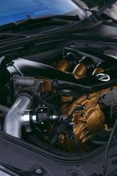 A close up of a car engine with its hood open