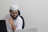 A man sitting in front of a laptop computer