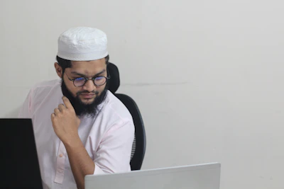 A man sitting in front of a laptop computer