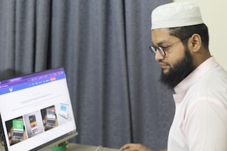 A man sitting at a desk using a computer