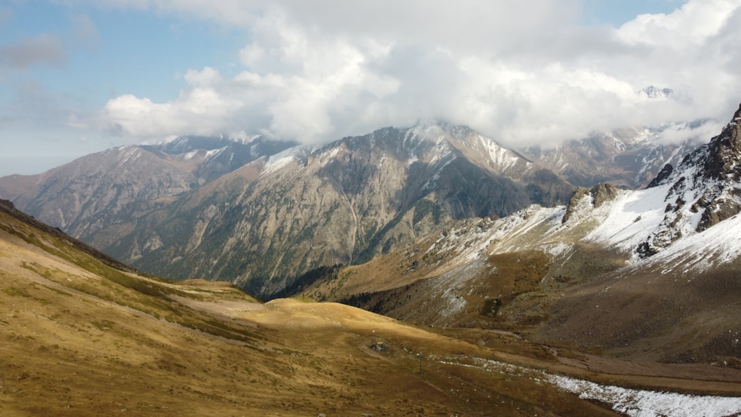 The mountains are covered in snow and clouds,