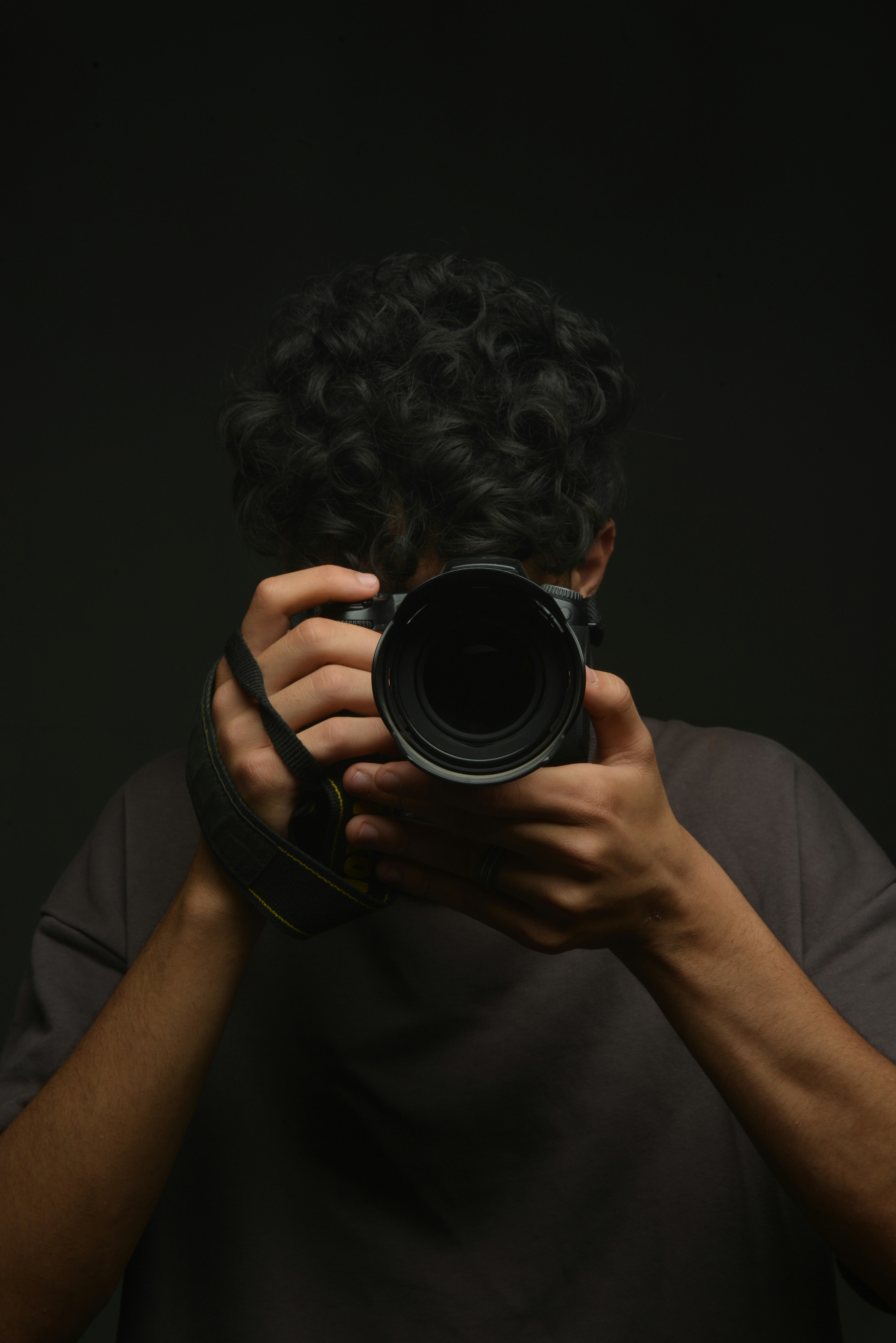 A man holding a camera up to his face